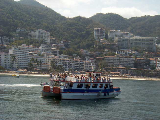 Cruise the bay on a catamaran, one of the many things to do when you buy a condo for sale in Puerto Vallarta.