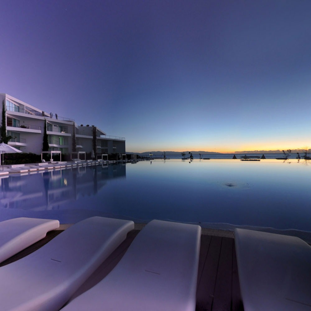 Huge infity beachfront pool in the evening in Acqua beachfront condominiums for sale in Riviera Nayarit.