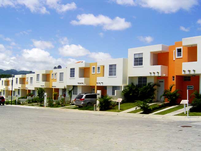 White, yellow and orange two story town homes for sale in Bucerias on a sunny day.