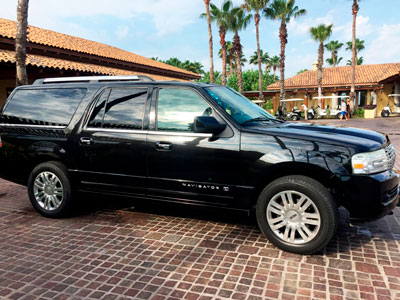 Full sized luxury black SUV, Lincoln Navigator on a sunny day. Available for transfers or transportation in Puerto Vallarta.