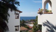 Traditional buildings with bugambilias on the terraces overlooking the bay. Selva Romantica condos for sale downtown Puerto Vallarta.