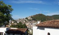 Selva Romantica buildings traditionally painted in white with red tiled roofs. Condos for sale in Downtown Puerto Vallarta, Mexico.