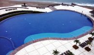 Huge common beachfront swimming pool with awesome sandy beach and natural pool at Tres Mares Puerto Vallarta.