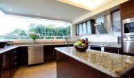 Lots of light in your modern kitchen with granite counter tops and stainless steel appliances included in your villa for sale in Puerto Vallarta.