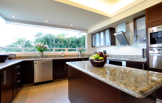 Lots of light in your modern kitchen with granite counter tops and stainless steel appliances included in your villa for sale in Puerto Vallarta.