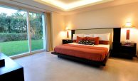 Master bedroom with modern furnish sliding doors and green gardens, villas for sale in Puerto Vallarta, Mexico