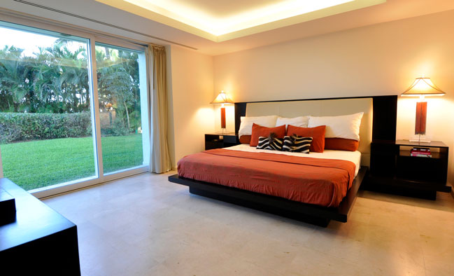 Master bedroom with modern furnish sliding doors and green gardens, villas for sale in Puerto Vallarta, Mexico