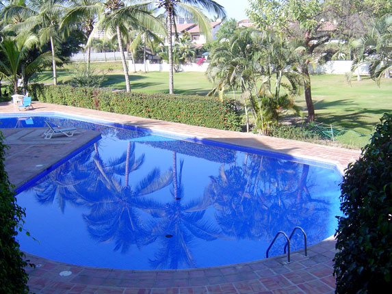 Common swimming pool with fairway view at Marina Golf, Puerto Vallarta real estate for sale by owner.