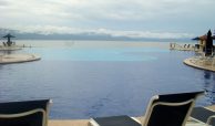 Infinity common pool, beachfront on a cloudy day with mountains in the back ground in Puerto Vallarta.