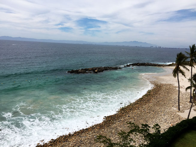 South shore of Puerto Vallarta, beachfront break wave creating awesome beach and natural swimming pool on a sunny day.