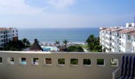 View from terrace of beach and swimming pools and other condo buildings in Riviera Nayarit.