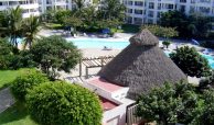 Common pool and palapa surrounded by condo buildings in Flamingos Beach and Golf condos in Nuevo Nayarit.