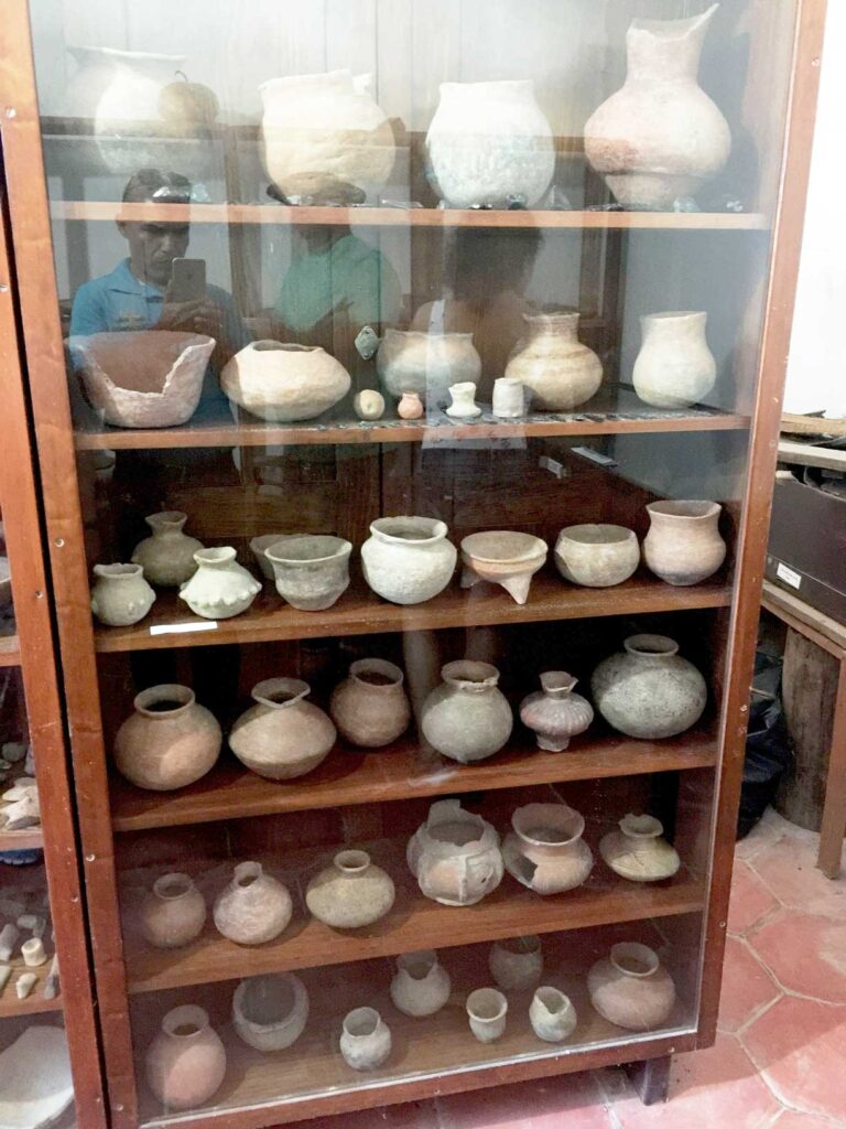 shelf full of pottery pre native