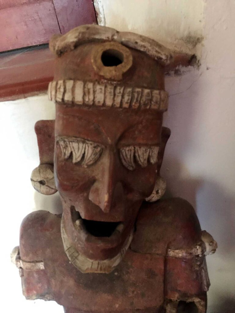Interesting red clay old man recovered in ruins in puerto vallarta